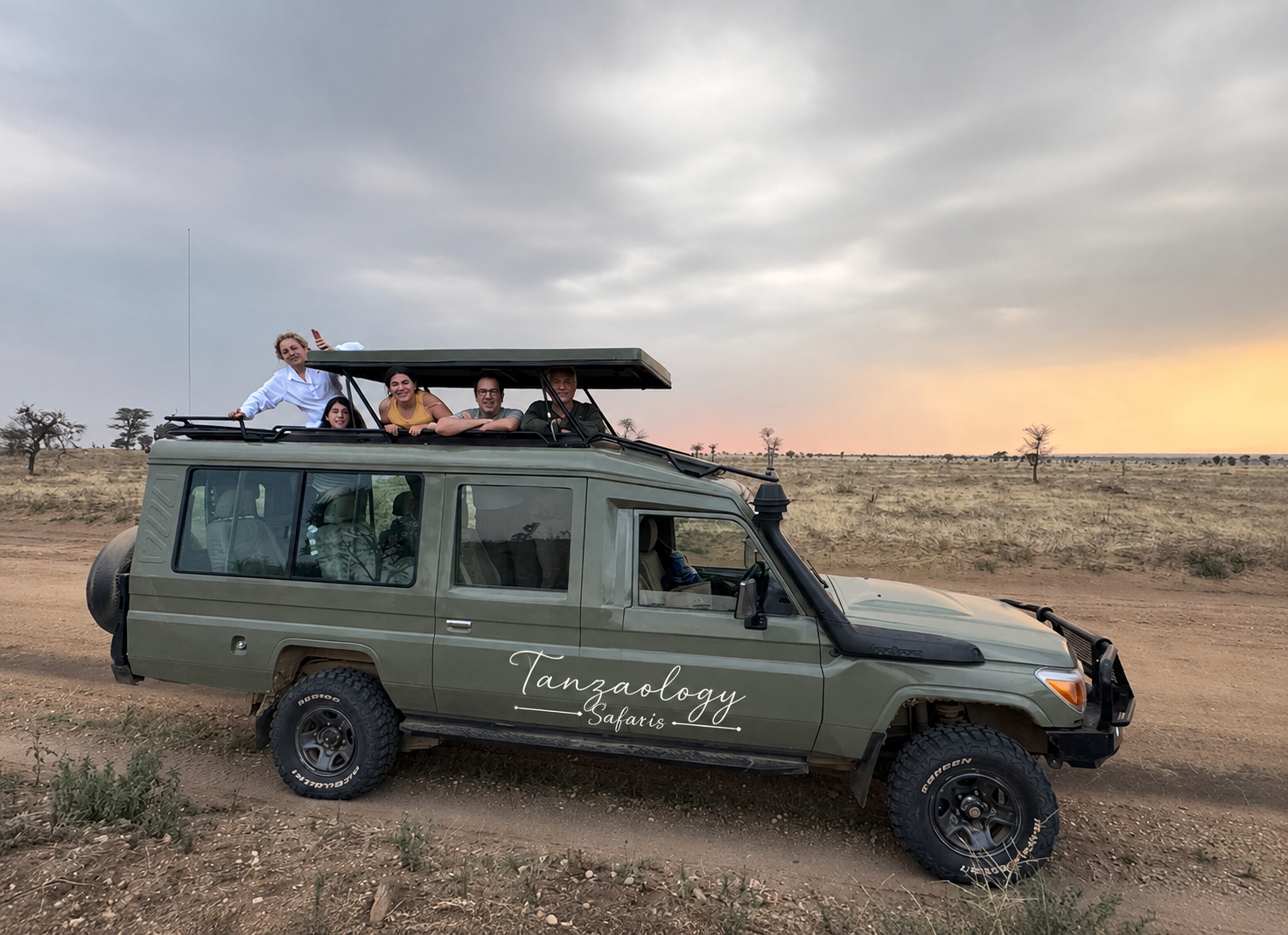 A Tanzaology Land Cruiser on the plains at dusk